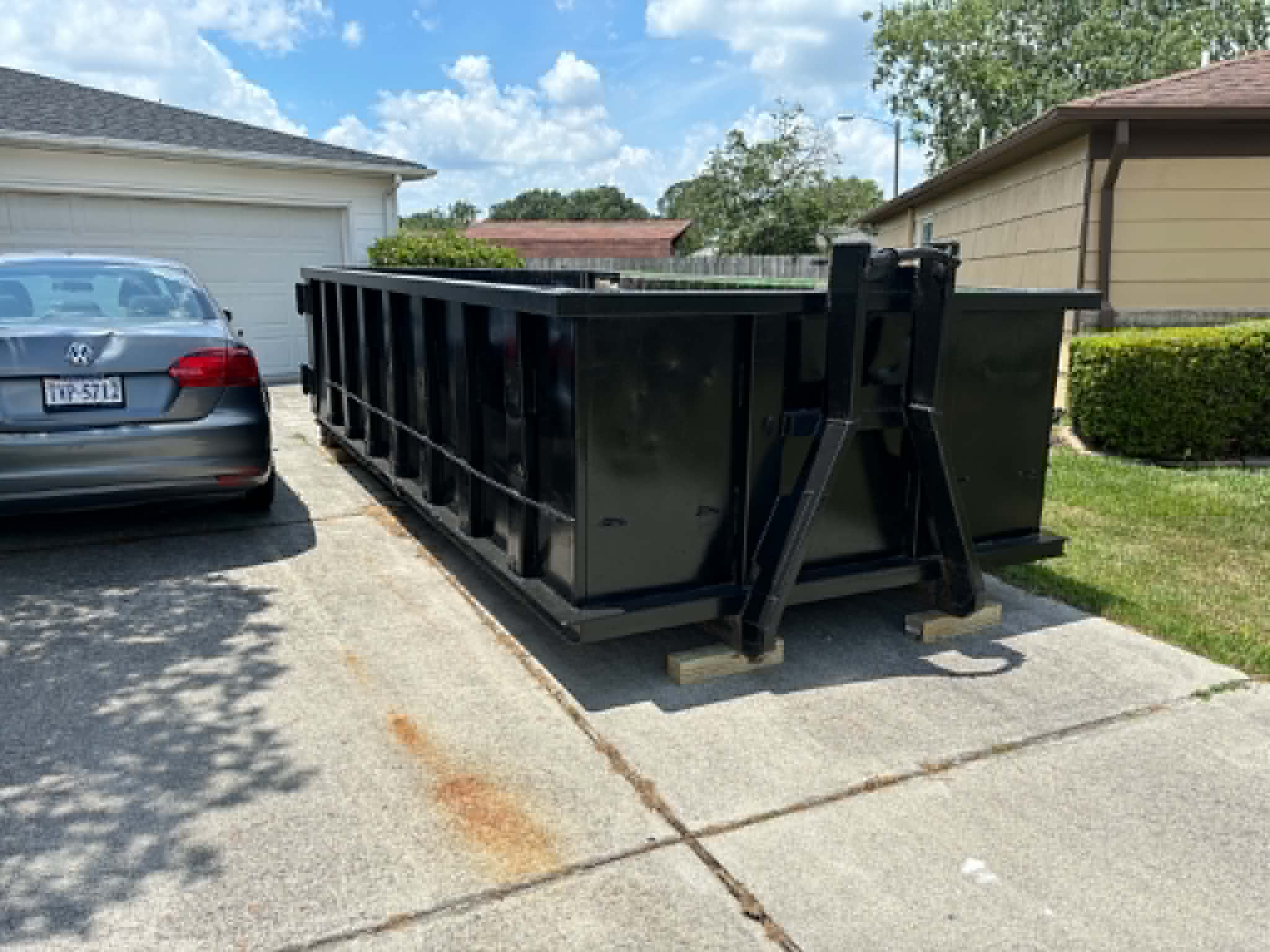 RISE Dumpsters 15-yard construction dumpster loaded with remodeling debris at a residential job site.